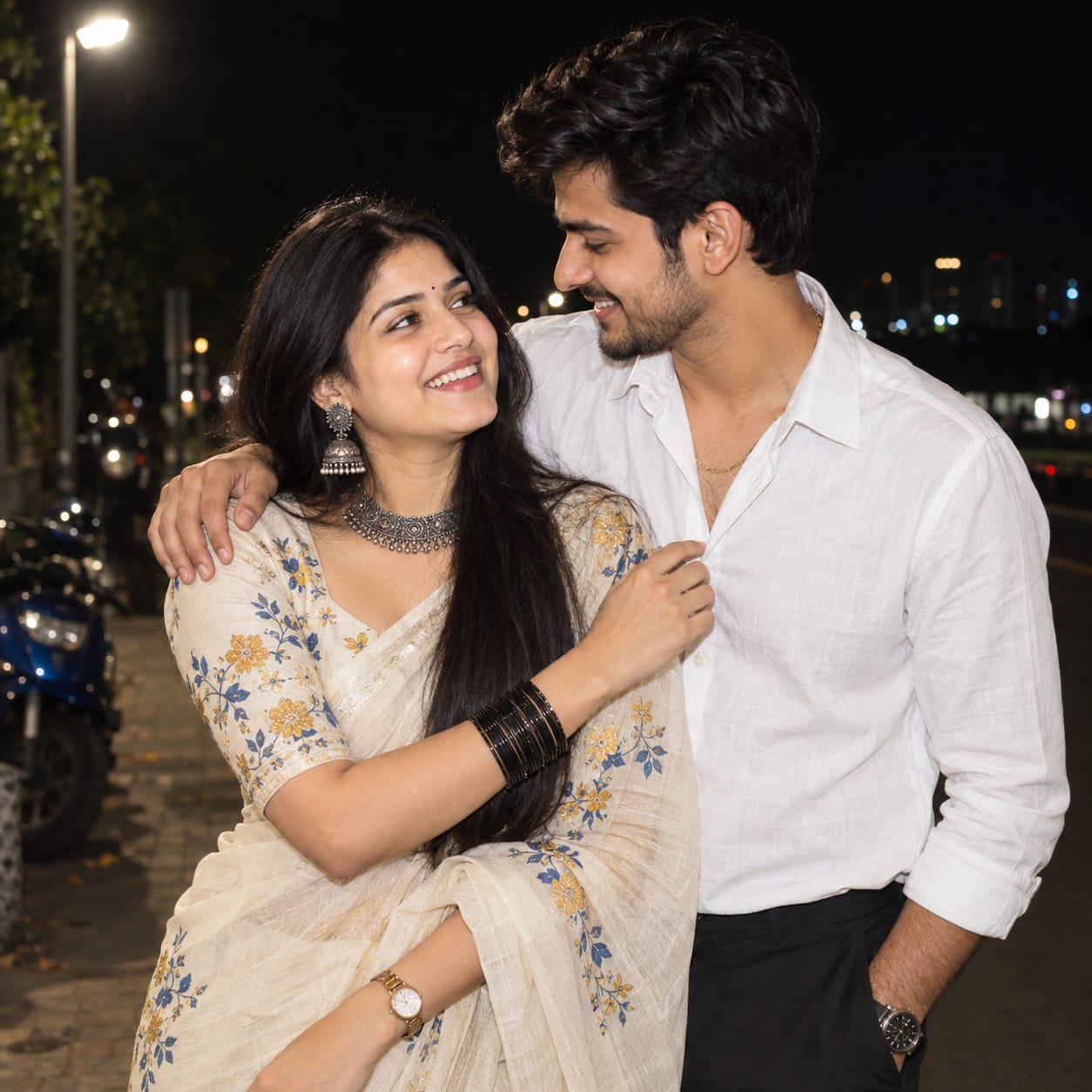 Indian couple laughing together on a dark urban street at night, captured with direct frontal flash and cinematic background bokeh.